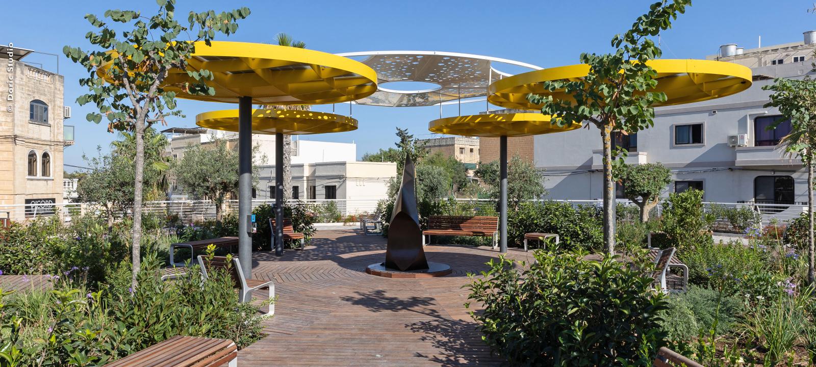 Roof garden with wooden podium and yellow canopies