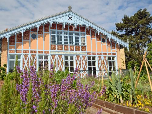 Herb and vegetable plots in front of a historic building