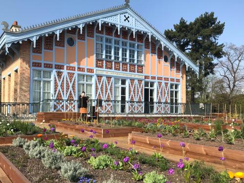 Herb and vegetable plots in front of a historic building
