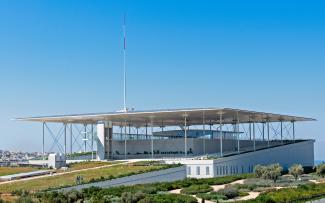 Building with a flat roof and vegetated areas on a green roof