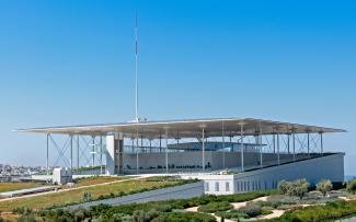 Building with a flat roof and vegetated areas on a green roof